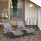 Pair of grey rocking sun lounger chairs with armrests and headrest pillows