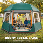 Green cabin tent with front opening, side panels, and mesh windows; family inside