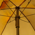 Brown sun umbrella canopy with monkey center panel and umbrella support pole