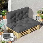 Charcoal grey padded seat and back cushions with tufted button detailing on pallet frame