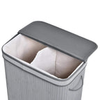 Grey laundry basket with flip lid open, white liner inside, side handles.