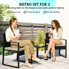 Rattan bistro set for 2 with two dark wicker chairs and tan seat cushions, glass table
