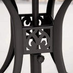 Close-up of black cast aluminium table base with ornate cut-out lattice