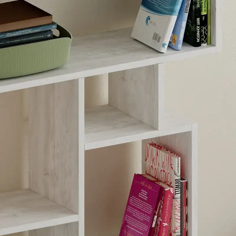 Tall bookcase display unit with open cubby shelves and white finish, corner view