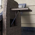 Brown reclining rattan armchair detail view showing side structure and blue-grey cushion edge