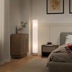 Cream linen floor lamp with tall fabric shade and pine wood base in bedroom