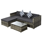 Grey rattan garden sectional sofa set with cushions and striped throw pillows