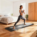 Grey tri-fold workout mat with carrying strap handles, used for lunges