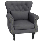 Dark grey Chesterfield-style accent chair with tufted back and nailhead trim