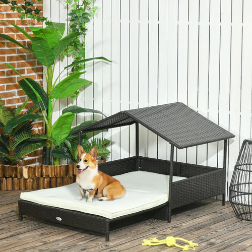 Dark rattan-style elevated dog house bed with slanted roof and cream cushion base