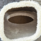 Close-up of plush-lined cat doorway on grey sisal scratcher barrel