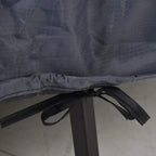 Close-up of grey cover underside with black drawstrings gathered at the hem