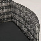 Grey rattan chair armrest and seat cushion edge with woven wicker detail