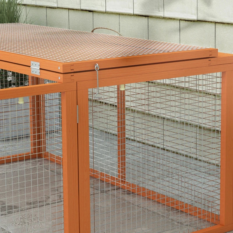 Orange rabbit hutch corner close-up with wire mesh walls and top bars.