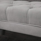 Grey upholstered bench side with stitched trim and tufted upholstery