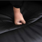 Close-up of black PU leather chair upholstery with visible stitching detail