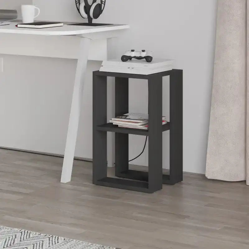 Modern bedside table with white top and dark frame, open storage with stacked magazines