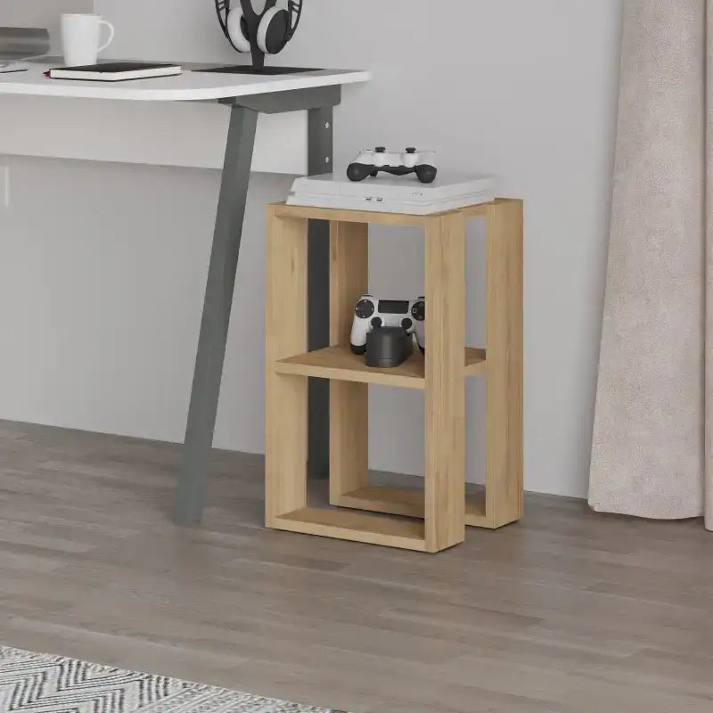 Light oak bedside table with open shelves and top surface, placed beside a chair.