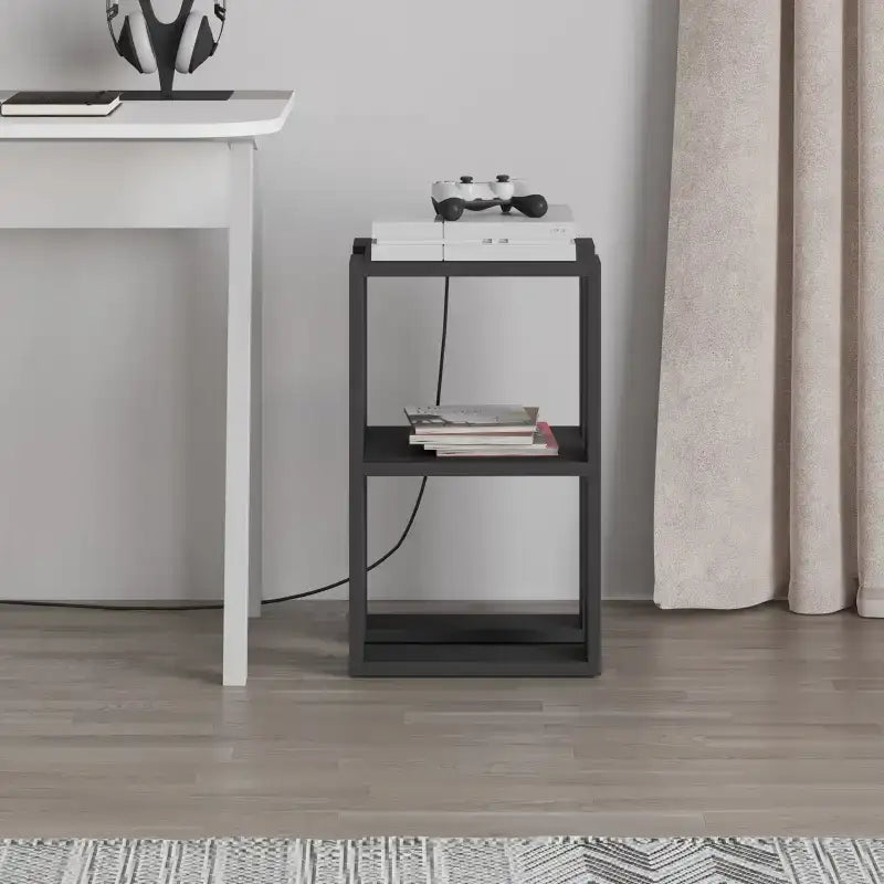 Modern bedside table with white top and dark frame, open shelves with books and game controller