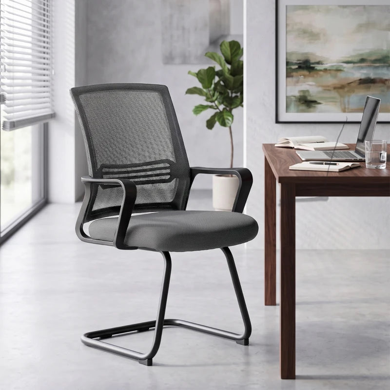 Dark grey mesh office chair with padded seat, armrests, and curved sled base
