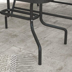 Dark metal armrest and curved frame legs with foot caps