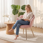 Pink velvet armchair with heart pillow on back and gold-tone metal legs