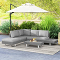 Light grey rattan sectional sofa set with cushions and woven coffee table