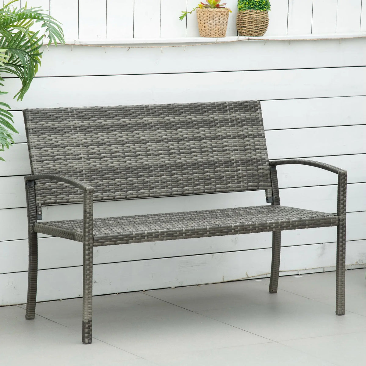 Grey woven garden loveseat with armrests and a two-person seat