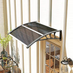 Black door canopy awning with curved translucent panel and wall-mounted support brackets