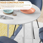 Close-up of white round tabletop edge and legs on a folding dining table base.