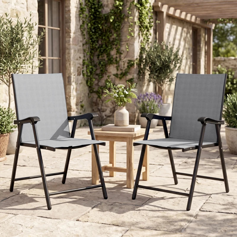 Two light gray high-back folding patio chairs with black frames and armrests