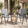 Two light gray high-back folding patio chairs with black frames and armrests