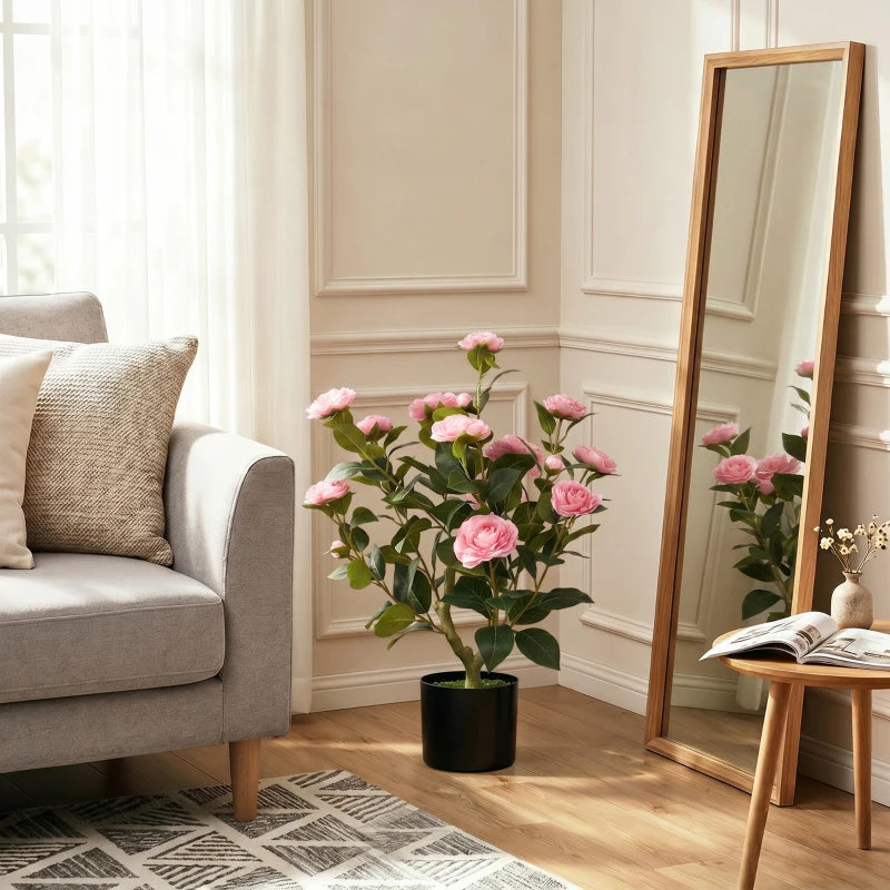 Pink camellia artificial plant with green foliage and pink flowers in a black pot