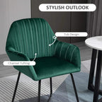 Green velvet-touch accent chair with channel tufting and curved arms, black metal base
