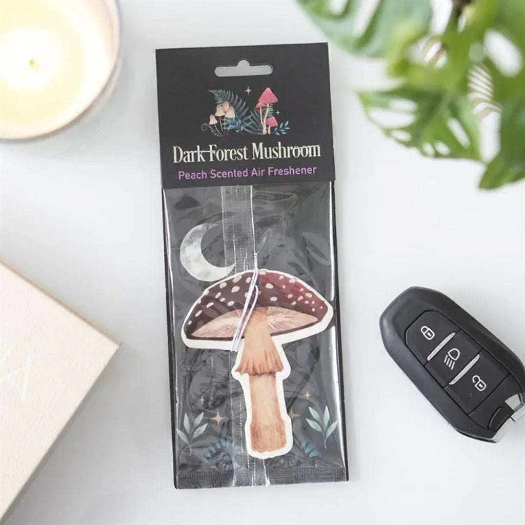 Peach-scented mushroom air freshener in dark forest themed hanging package