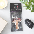 Peach-scented mushroom air freshener in dark forest themed hanging package