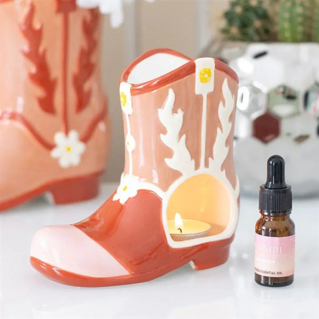 Orange cowboy boot oil warmer candle holder with decorative white cowboy pattern