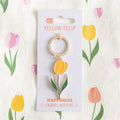 Yellow tulip enamel keyring with gold-tone ring and tulip charm on card