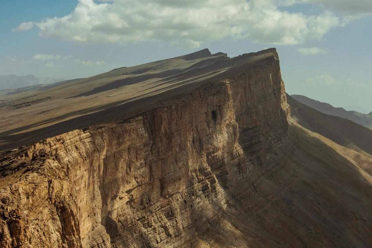 Large cliff face in a desert landscape with a clear sky