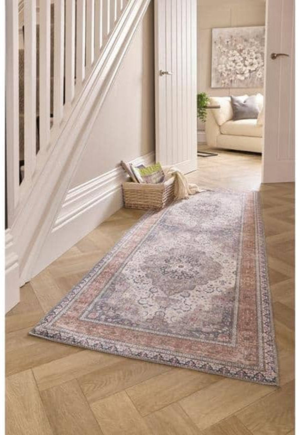 Long rectangular rug on a wooden floor in a home setting with a staircase and living room.