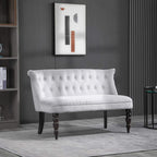 Grey velvet wingback loveseat with button tufting and dark wood legs