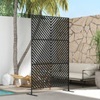 Black metal outdoor privacy divider with triangle pattern on freestanding stand, side view
