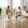 Folding dining table with round light wood top and white steel frame, 4-person setup