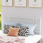 White metal double bed frame with headboard, slatted base, and pillows on top