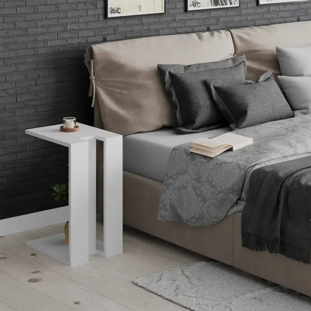 White C-shaped side table with dark tabletop and open lower shelf