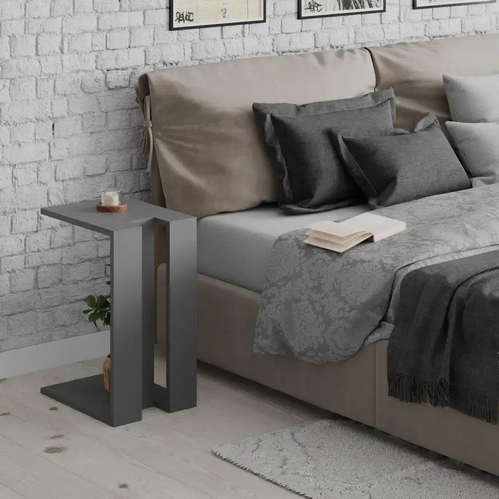 Dark gray C-shaped side table with open lower shelf
