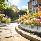 Silver corrugated steel edging border curved around a paved walkway next to flowers