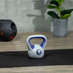 6 kg kettlebell with purple handle and grey body, standing on floor mat
