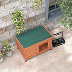 Wooden outdoor dog kennel with green top panel and arched front entrance, orange wood
