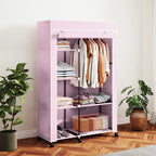 Pink folding fabric wardrobe with shelves and hanging rail, rolling casters, open front.